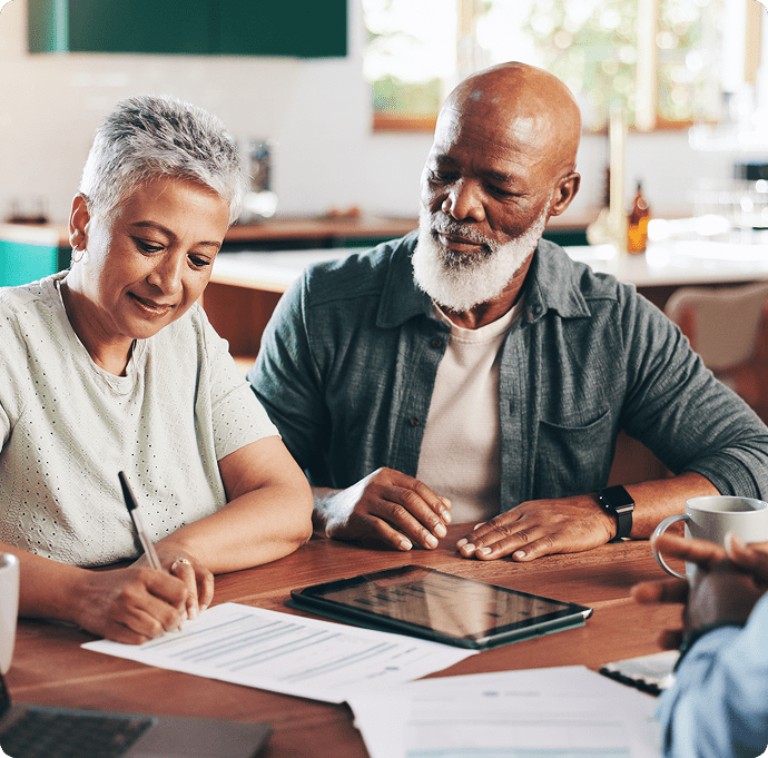 Older adults discussing paperwork at home